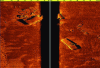 Figure 20 - Example of side scan sonar acquisition (4200: Multi-Purpose Survey System from EdgeTech). A black band can be seen in the center separating the images from the two side beams. This band corresponds to the sound path in the water column (i.e. without echo) before the first bottom echo appears. The image shows a wreck and debris. The shadows give information on the height of the debris (credit: Image courtesy of EdgeTech).